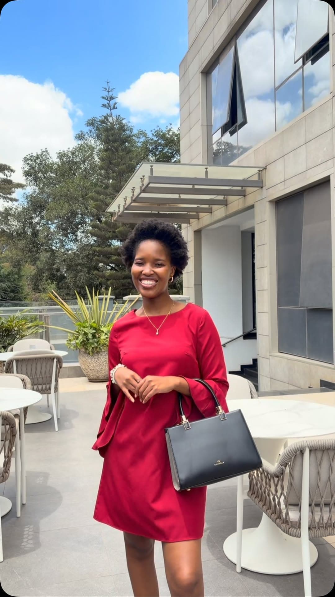 Woman in a red dress on a hotel terrace