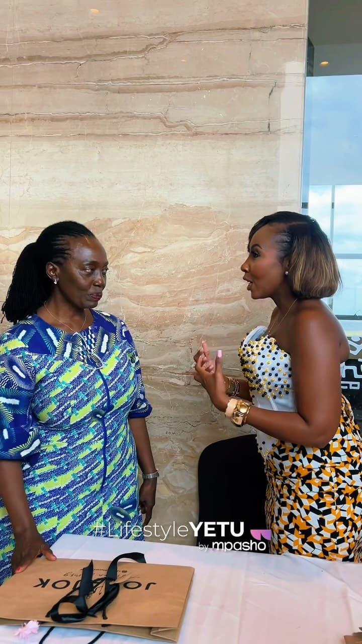 Two women in conversation at a press event