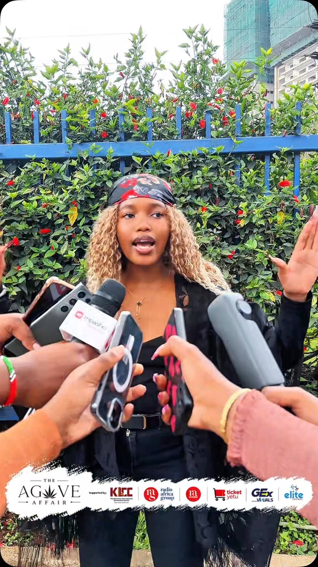 Press microphones held up to a speaker outdoors
